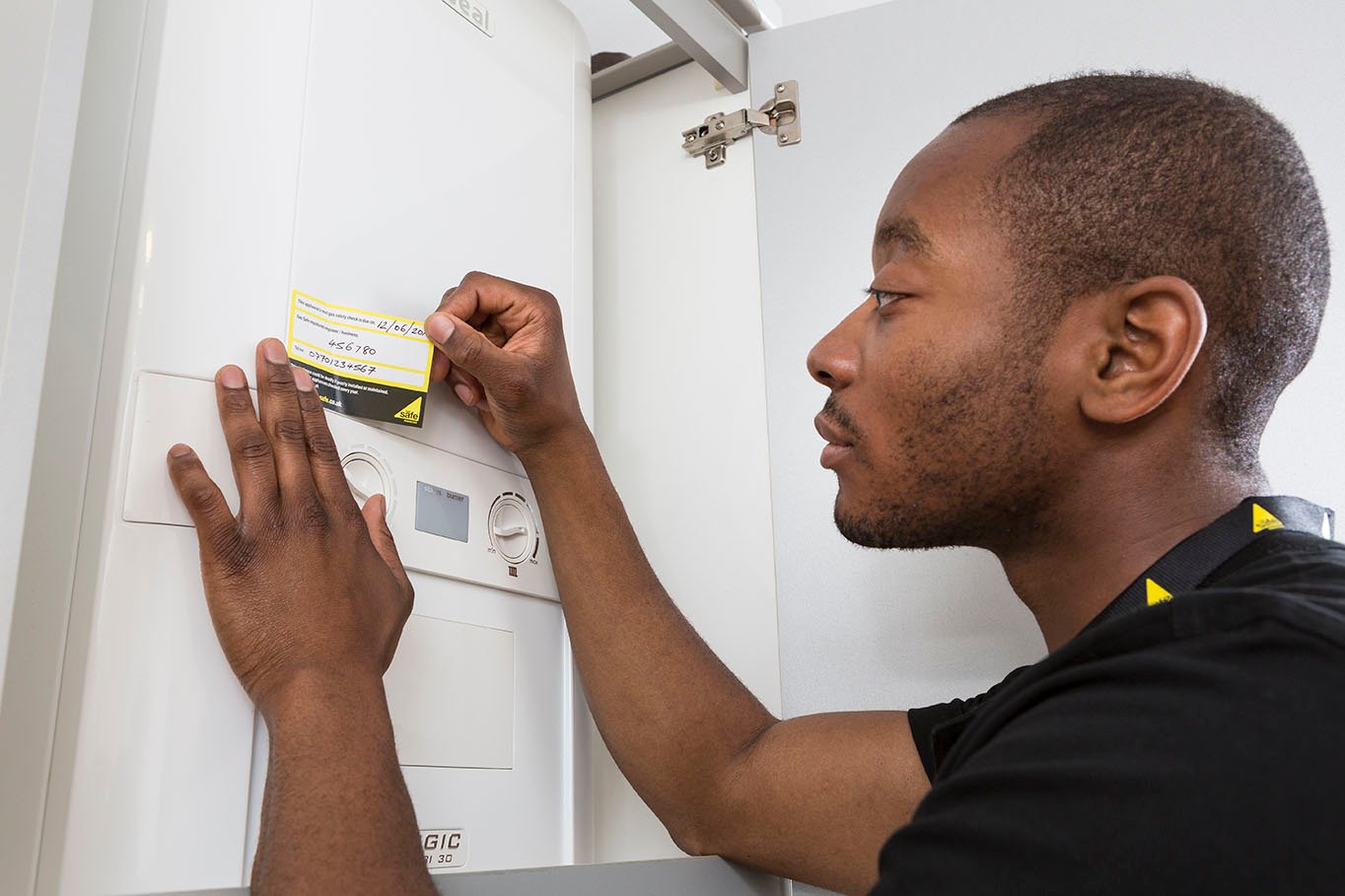 Engineer applying annual service sticker