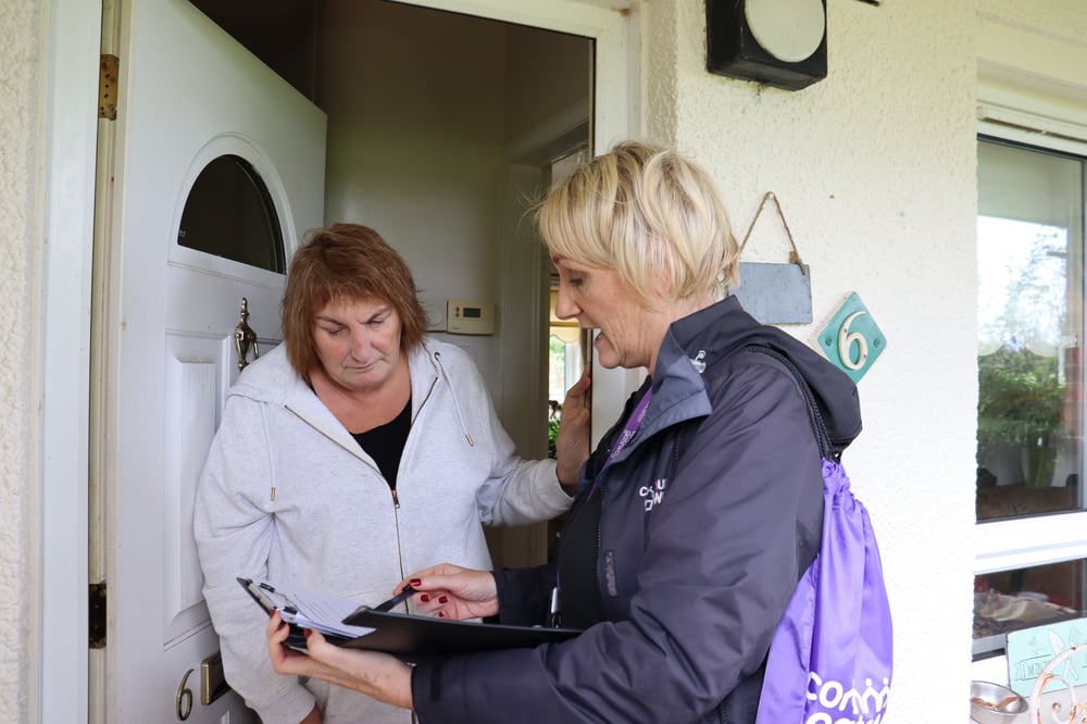 Showing a Community Engagement Officer speaking with a tenant on the doorstep